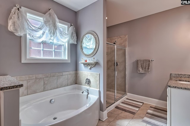 bathroom featuring tile patterned flooring, baseboards, a garden tub, a stall shower, and vanity