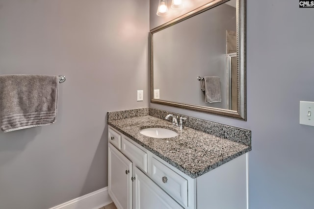 bathroom featuring baseboards and vanity