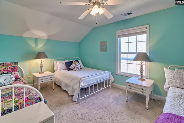 carpeted bedroom featuring visible vents, baseboards, ceiling fan, and vaulted ceiling