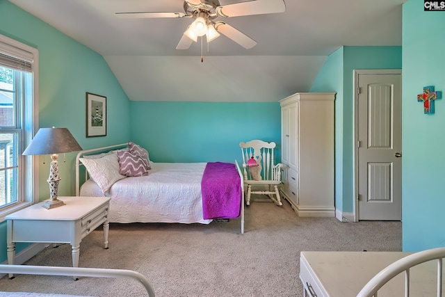 carpeted bedroom featuring a ceiling fan and vaulted ceiling