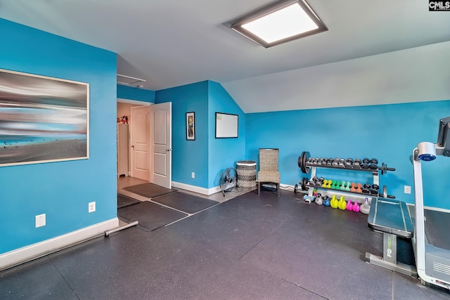 interior space with lofted ceiling and baseboards