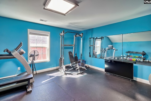 exercise area with a wealth of natural light, visible vents, and baseboards