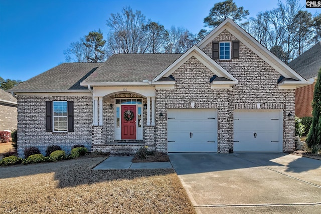 view of front facade with an attached garage, roof with shingles, and driveway