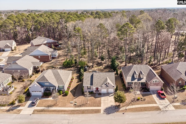 birds eye view of property featuring a forest view and a residential view