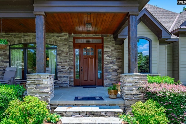 property entrance featuring stone siding and a porch