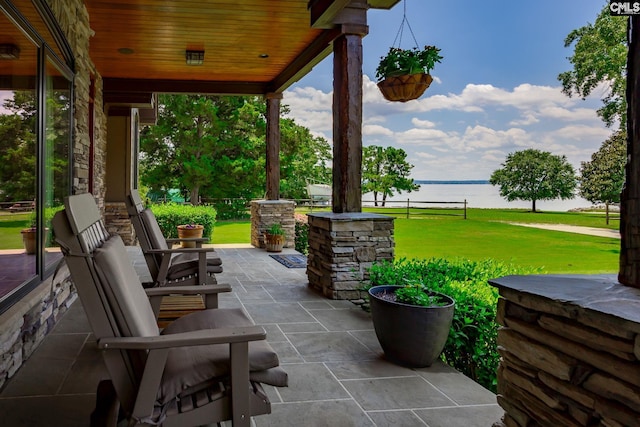 view of patio / terrace featuring covered porch and a water view