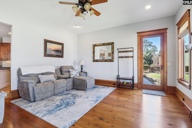 living area featuring recessed lighting, a healthy amount of sunlight, ceiling fan, and hardwood / wood-style flooring