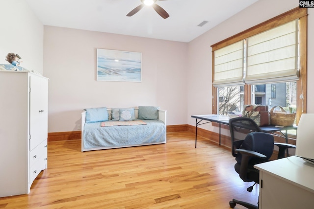 bedroom featuring visible vents, baseboards, and light wood-style floors