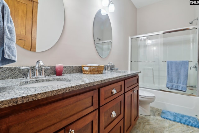 full bathroom featuring enclosed tub / shower combo, double vanity, toilet, and a sink