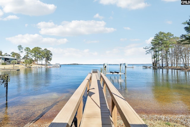 dock area with a water view and boat lift