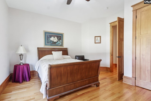 bedroom with ceiling fan, light wood-type flooring, and baseboards