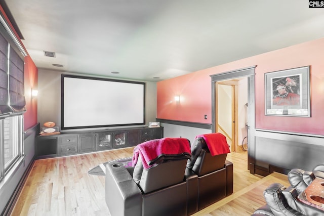 home theater room featuring wood finished floors and visible vents