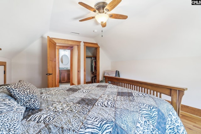 bedroom featuring visible vents, wood finished floors, baseboards, lofted ceiling, and ceiling fan