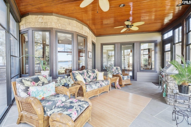 sunroom featuring wood ceiling, lofted ceiling, and a ceiling fan