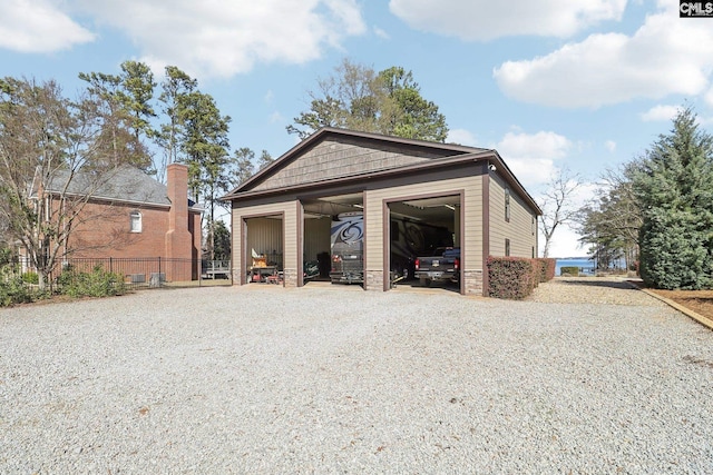 detached garage featuring fence