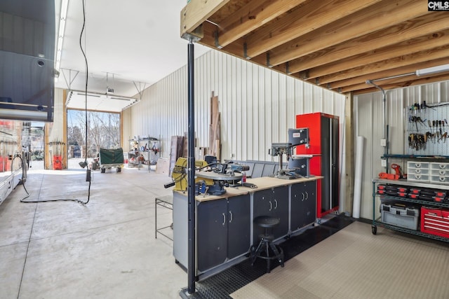 basement with metal wall and a workshop area