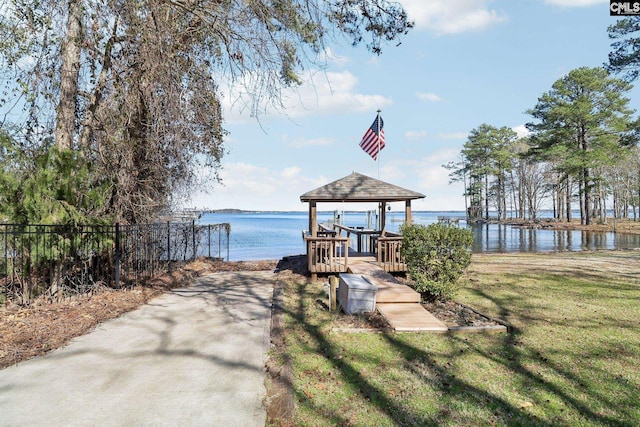 view of dock featuring a yard and a water view