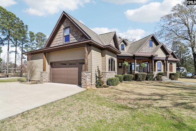 craftsman-style house with a front lawn, a garage, stone siding, and driveway