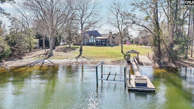 dock area featuring boat lift, a water view, and a lawn