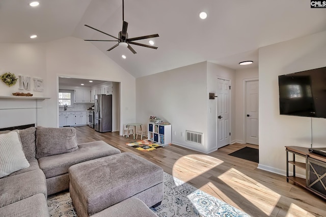 living area with recessed lighting, visible vents, light wood-style flooring, and a ceiling fan