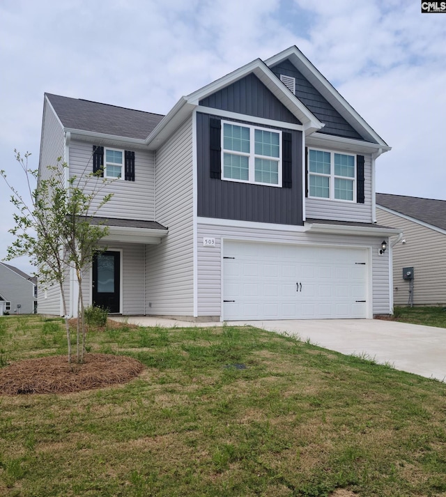 view of front of home featuring an attached garage, a front lawn, driveway, and board and batten siding