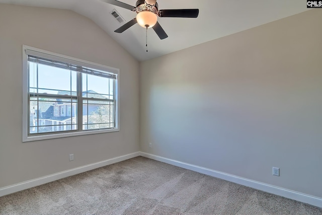 empty room featuring visible vents, a ceiling fan, carpet floors, baseboards, and vaulted ceiling