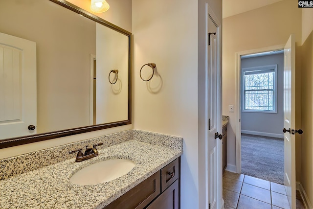 bathroom featuring vanity, tile patterned floors, and baseboards