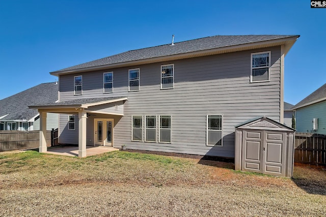 back of property featuring an outbuilding, fence, french doors, a storage shed, and a patio area