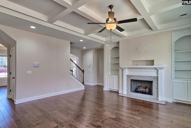 unfurnished living room featuring visible vents, ceiling fan, baseboards, built in features, and wood finished floors