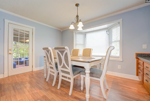 dining area with plenty of natural light, light wood finished floors, and ornamental molding