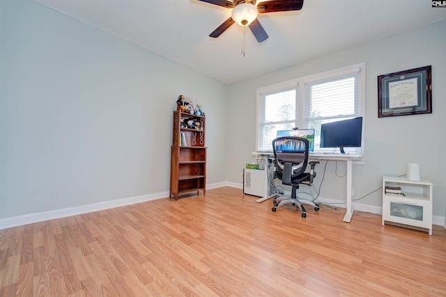 unfurnished office featuring light wood-style flooring, baseboards, and ceiling fan