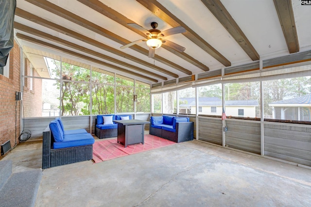 sunroom featuring beamed ceiling and ceiling fan