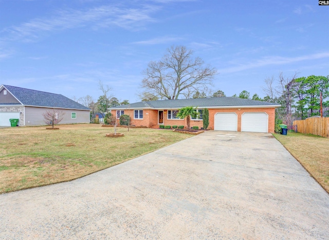 single story home featuring a front lawn, concrete driveway, fence, and a garage