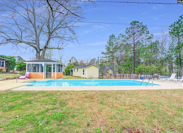 view of swimming pool featuring a yard, a fenced in pool, an outdoor structure, and fence