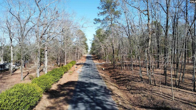 view of road featuring a forest view