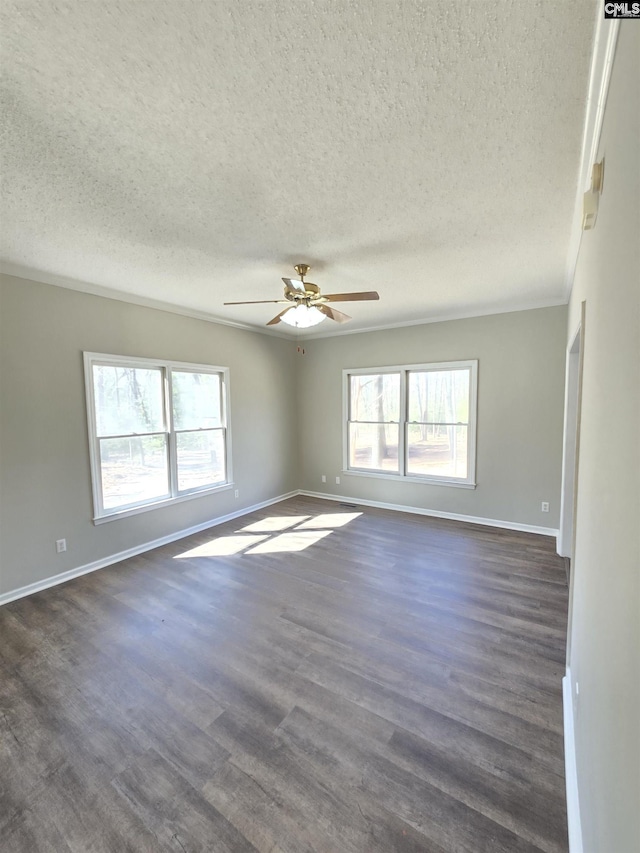 spare room with ceiling fan, a textured ceiling, baseboards, and dark wood-style flooring