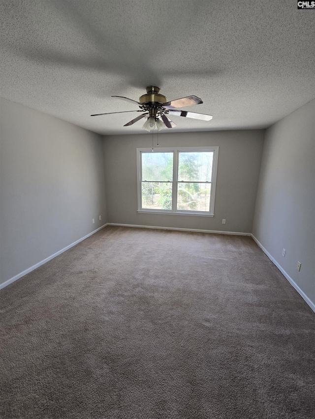 spare room with a textured ceiling, baseboards, a ceiling fan, and carpet floors