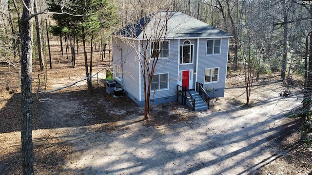 view of front facade with crawl space, central AC unit, and entry steps