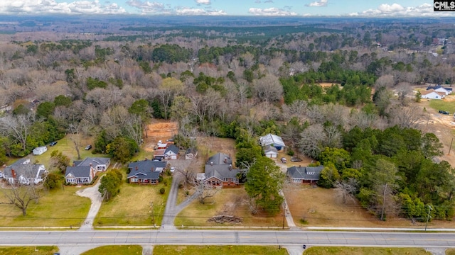 drone / aerial view featuring a wooded view