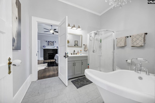 bathroom with a shower stall, a brick fireplace, crown molding, marble finish floor, and a ceiling fan