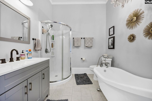 bathroom with vanity, baseboards, a stall shower, a freestanding bath, and ornamental molding