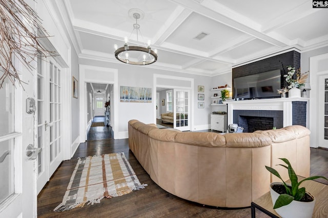 living room featuring visible vents, plenty of natural light, a notable chandelier, and dark wood finished floors