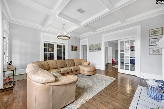 living room featuring visible vents, coffered ceiling, dark wood-style floors, and a notable chandelier