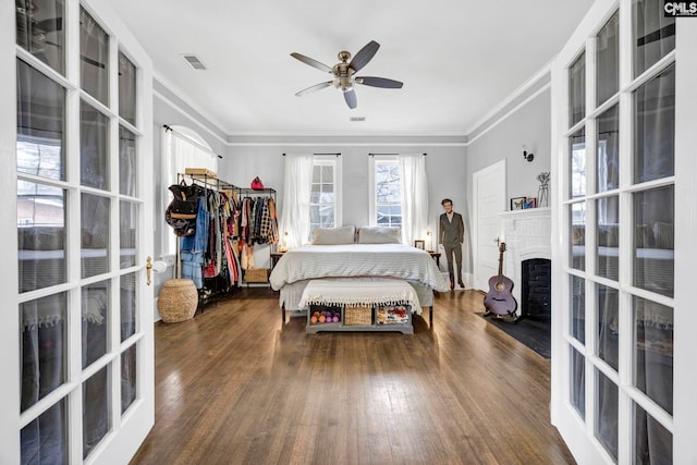 bedroom with hardwood / wood-style flooring, french doors, visible vents, and ornamental molding