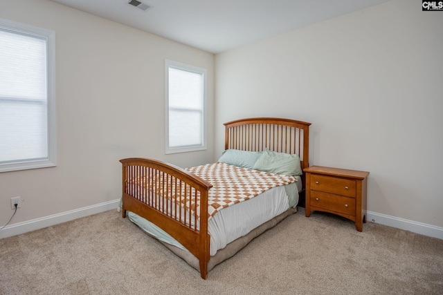 bedroom with carpet flooring and baseboards