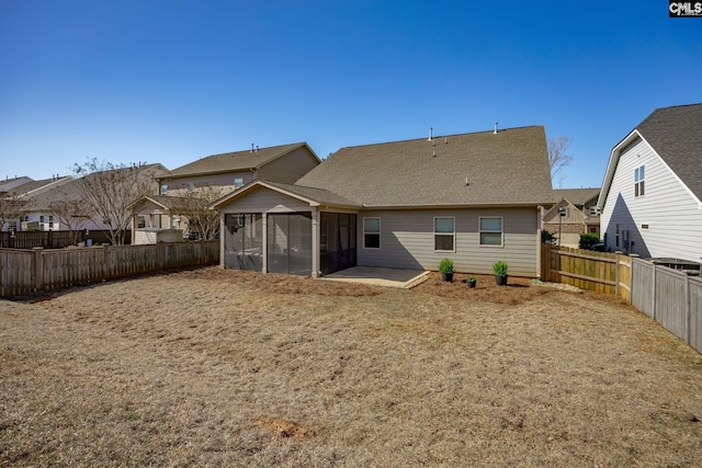 back of house with a patio, a fenced backyard, a residential view, and a sunroom