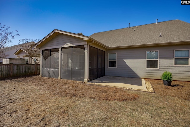 rear view of property with a patio area, fence, a sunroom, and a shingled roof