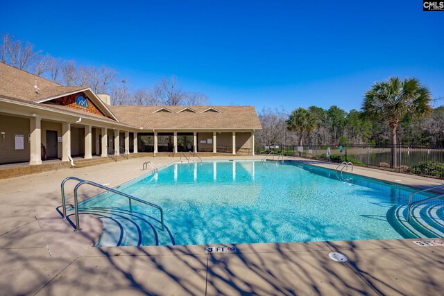 pool featuring fence and a patio area