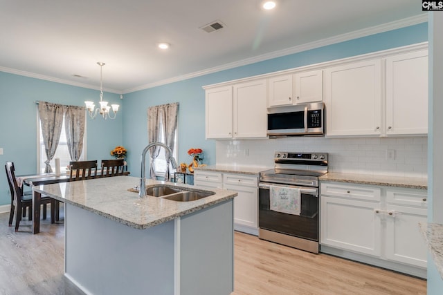 kitchen featuring visible vents, a notable chandelier, a sink, plenty of natural light, and appliances with stainless steel finishes