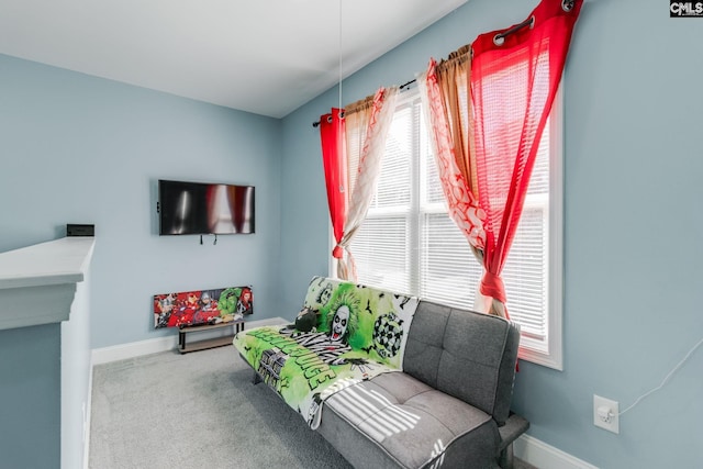 sitting room featuring carpet flooring and baseboards